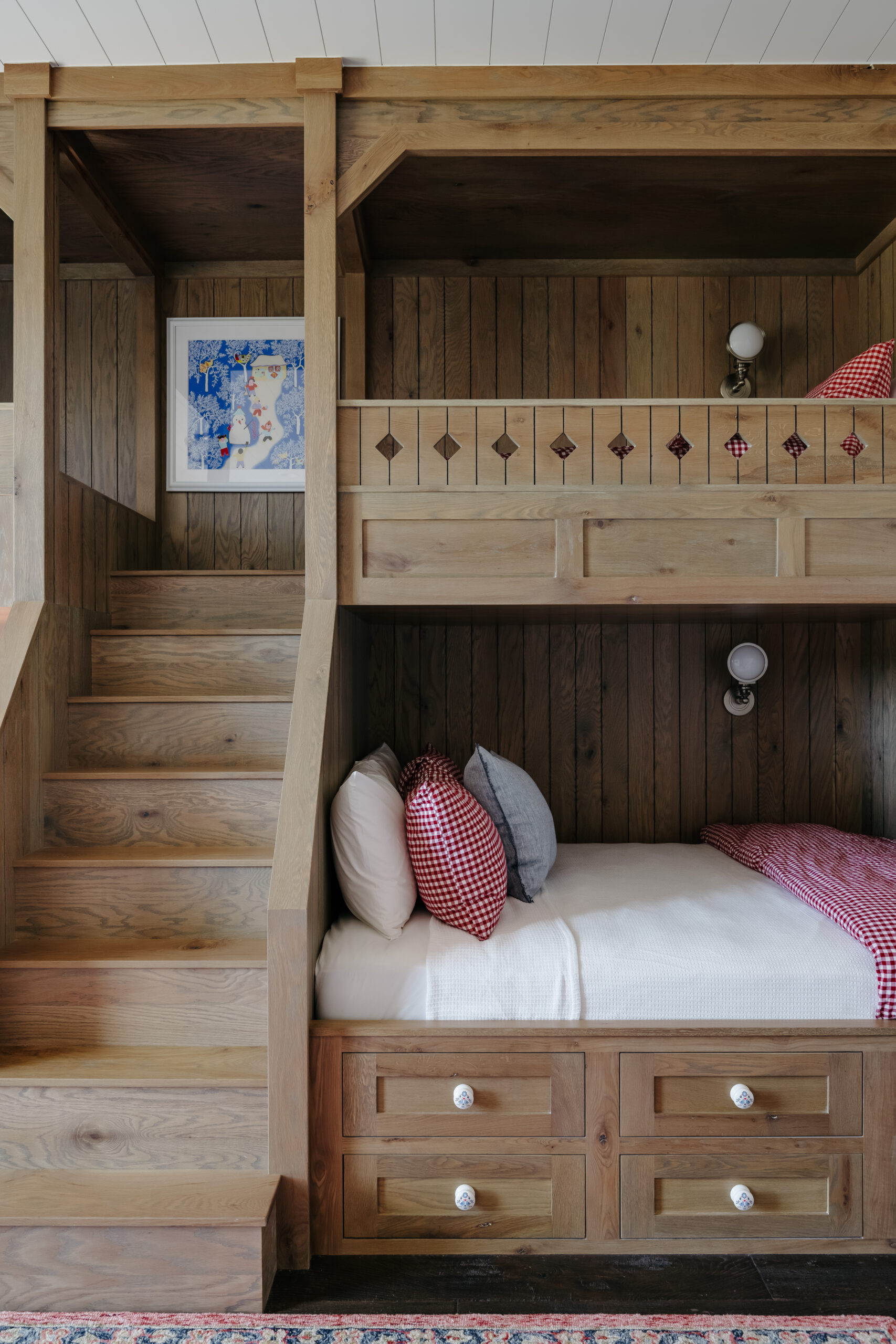 Charming wooden bunkbeds with detailed millwork and hand painted knobs.