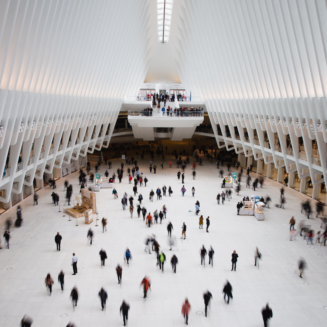 People walking through a large building. 